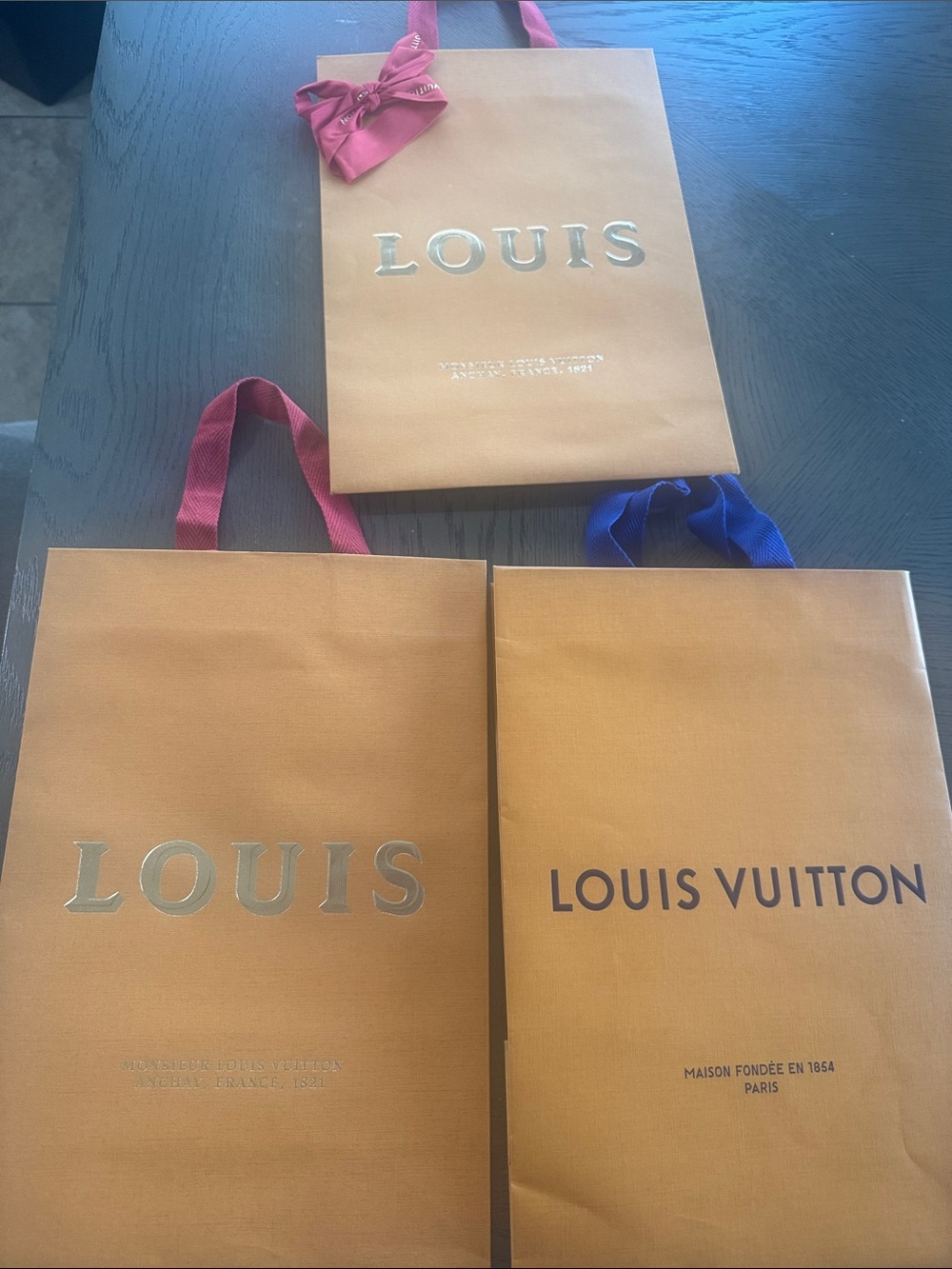 3 Louis Vuitton Orange Gift Bags with Red 
 and Blue Ribbon Handles